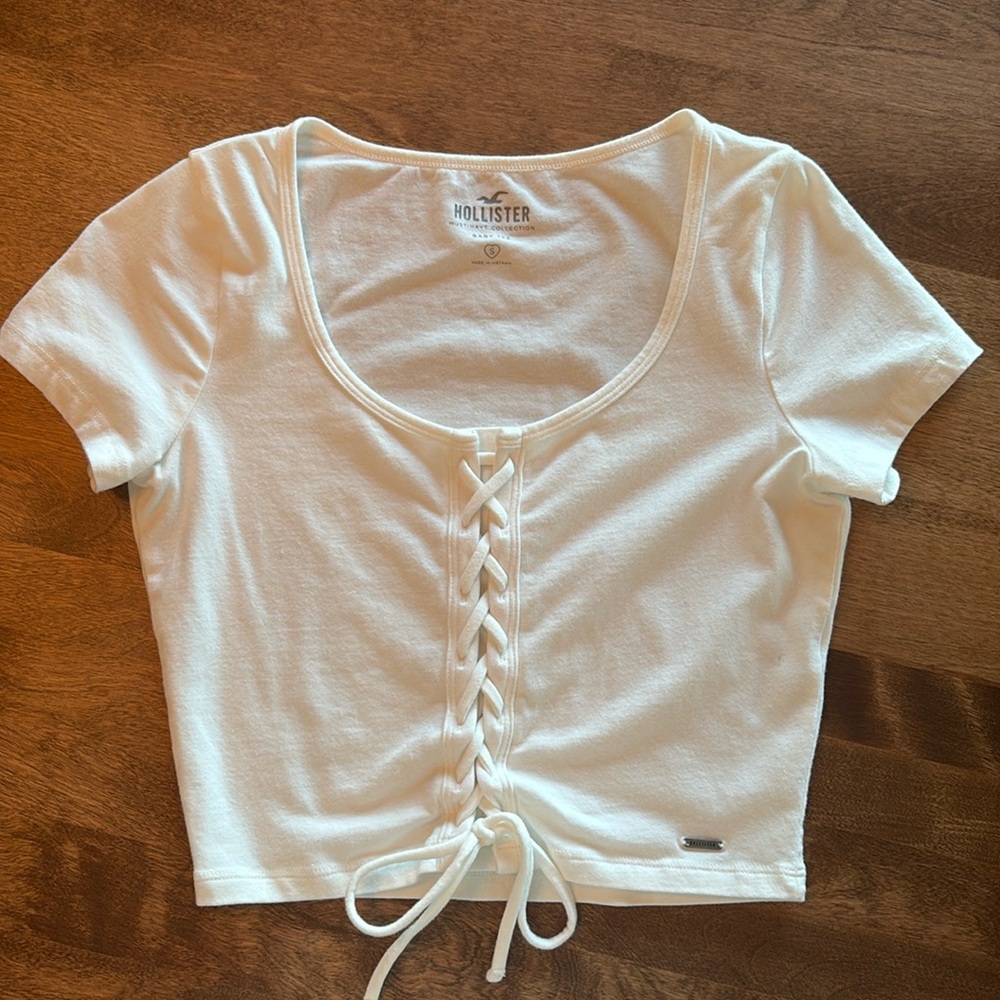 Hollister White Lace-up Baby Tee. Super soft, cute, washes up nice! No stains.